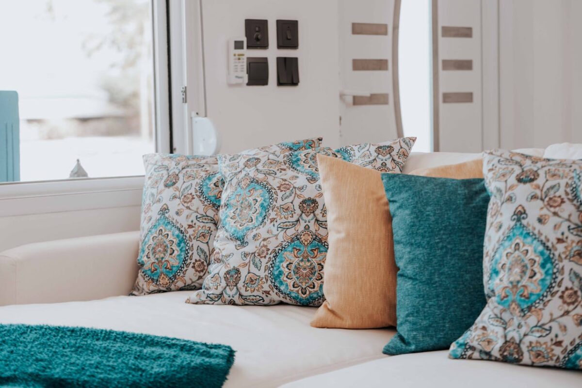 Cozy modern sofa with patterned and solid throw pillows for a chic living room look.